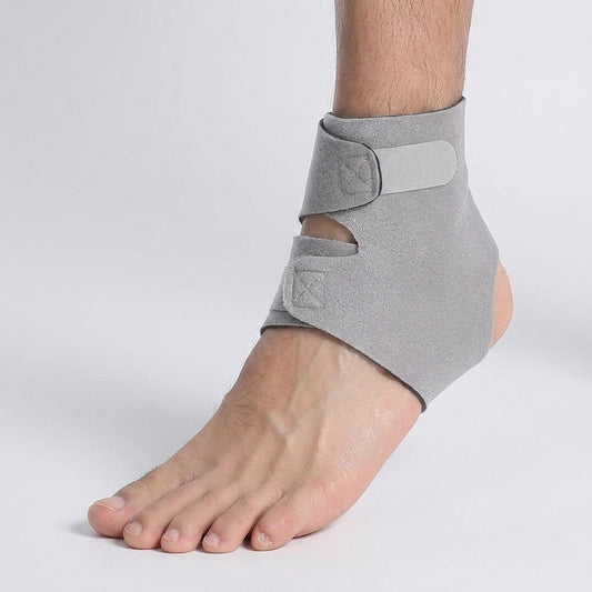 An achilles support brace shown on a person's ankle and foot against a plain light gray studio background.