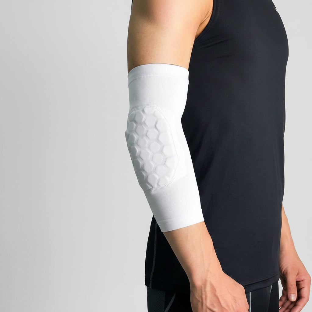 A kids honeycomb elbow pads on the forearm, shown worn on a person's elbow against a light gray background.