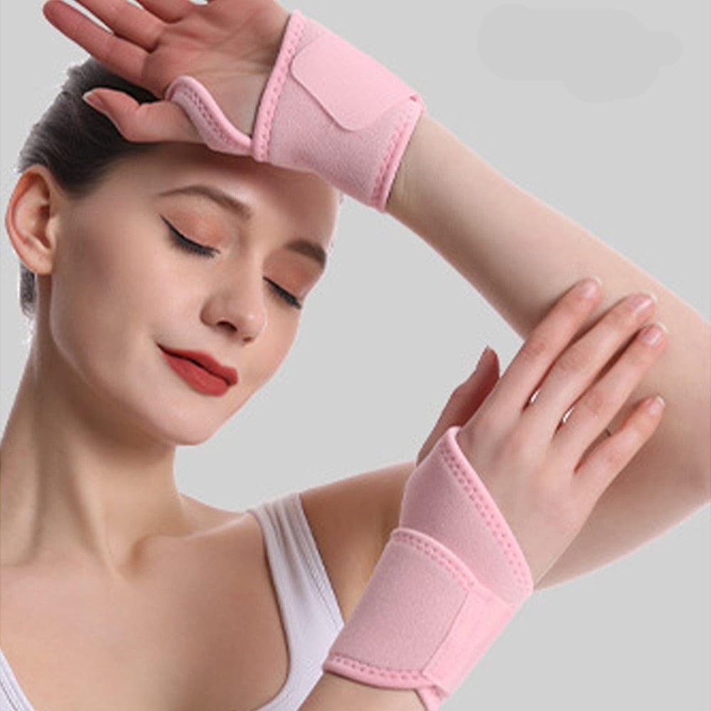 Front layout view of the pink Wrist Brace for Ganglion Cyst demonstrating its wide compression strap layout on an adult hand.