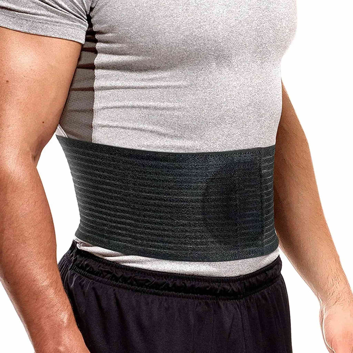 A close-up of a man's torso wearing an abdominal support belt with pressure pad, against a plain white background.