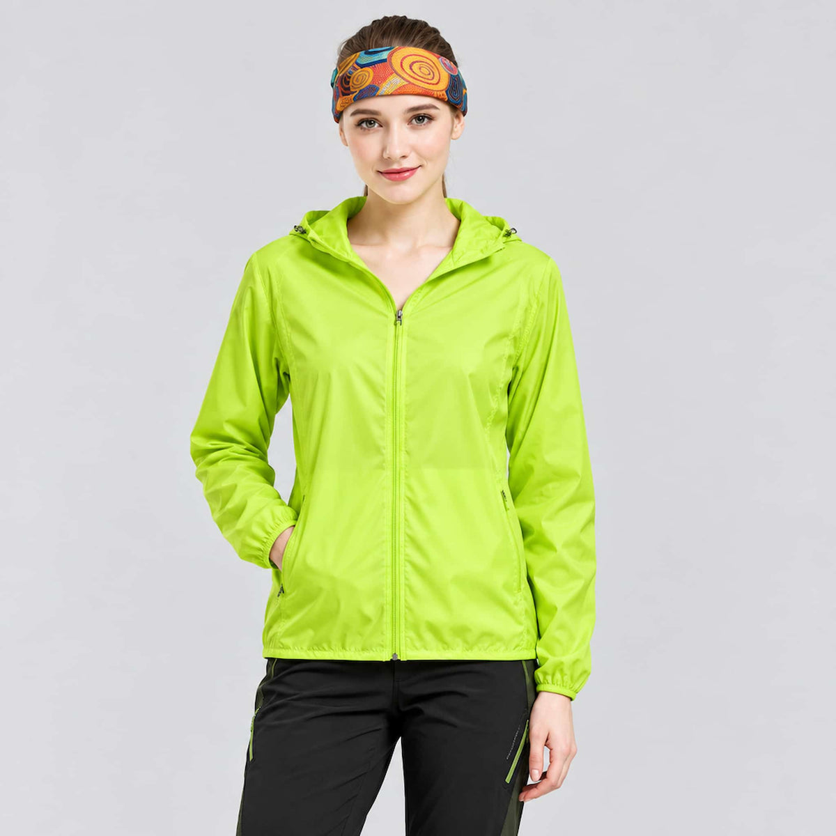 A woman wearing an anti-UV packable windbreaker, standing against a solid light gray background.