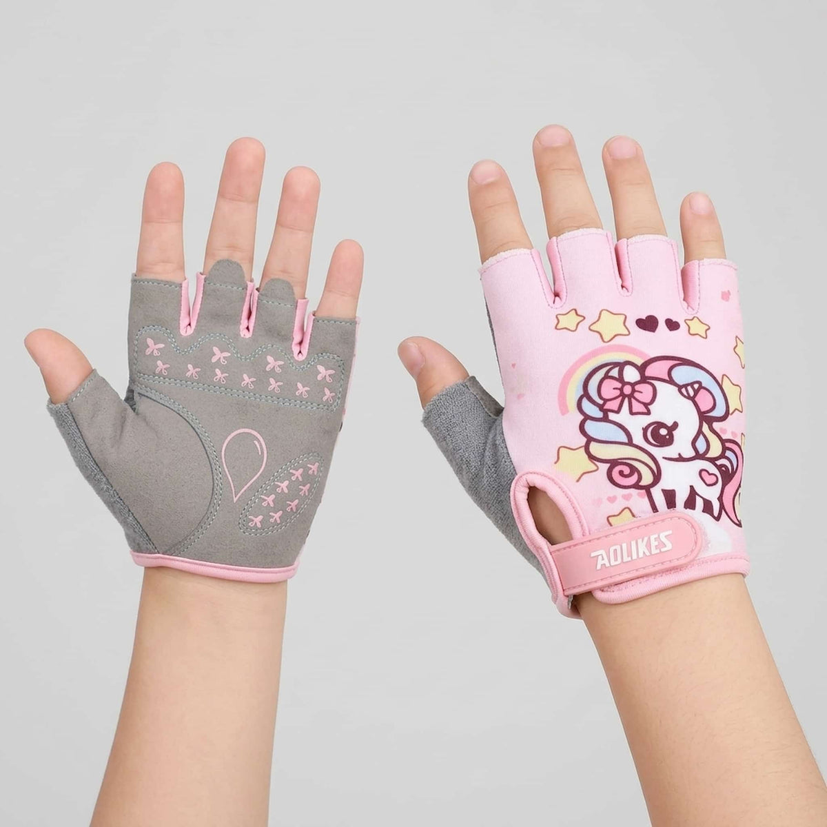 A pair of children's bicycle gloves shown on hands against a light gray background.