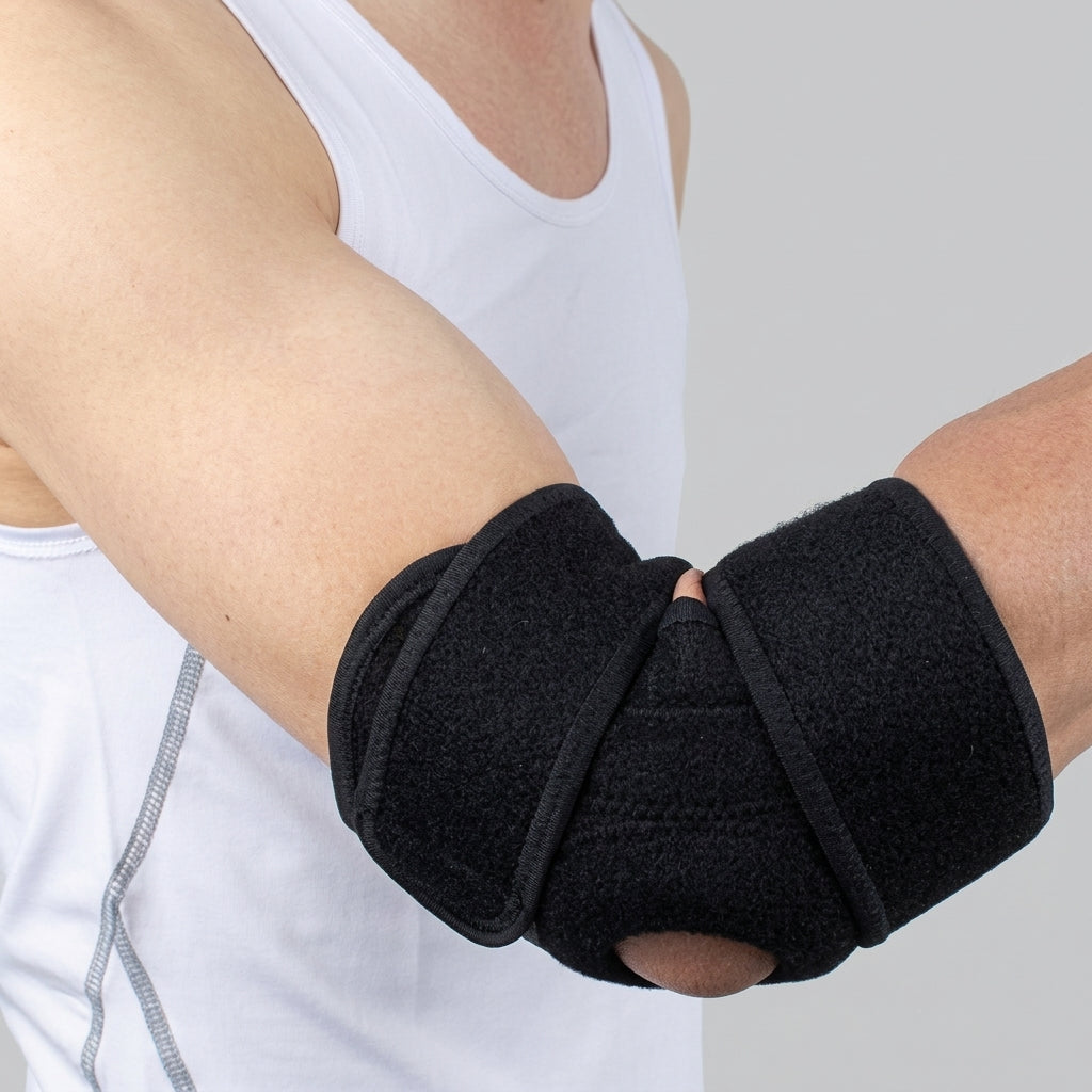 A close-up of a person's forearm and elbow wrapped in a elbow brace adjustable free size, wearing a white tank top against a light gray background.