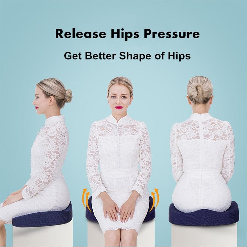 A person sitting at an office desk utilizing an ergonomic sitting support cushion to maintain proper posture.