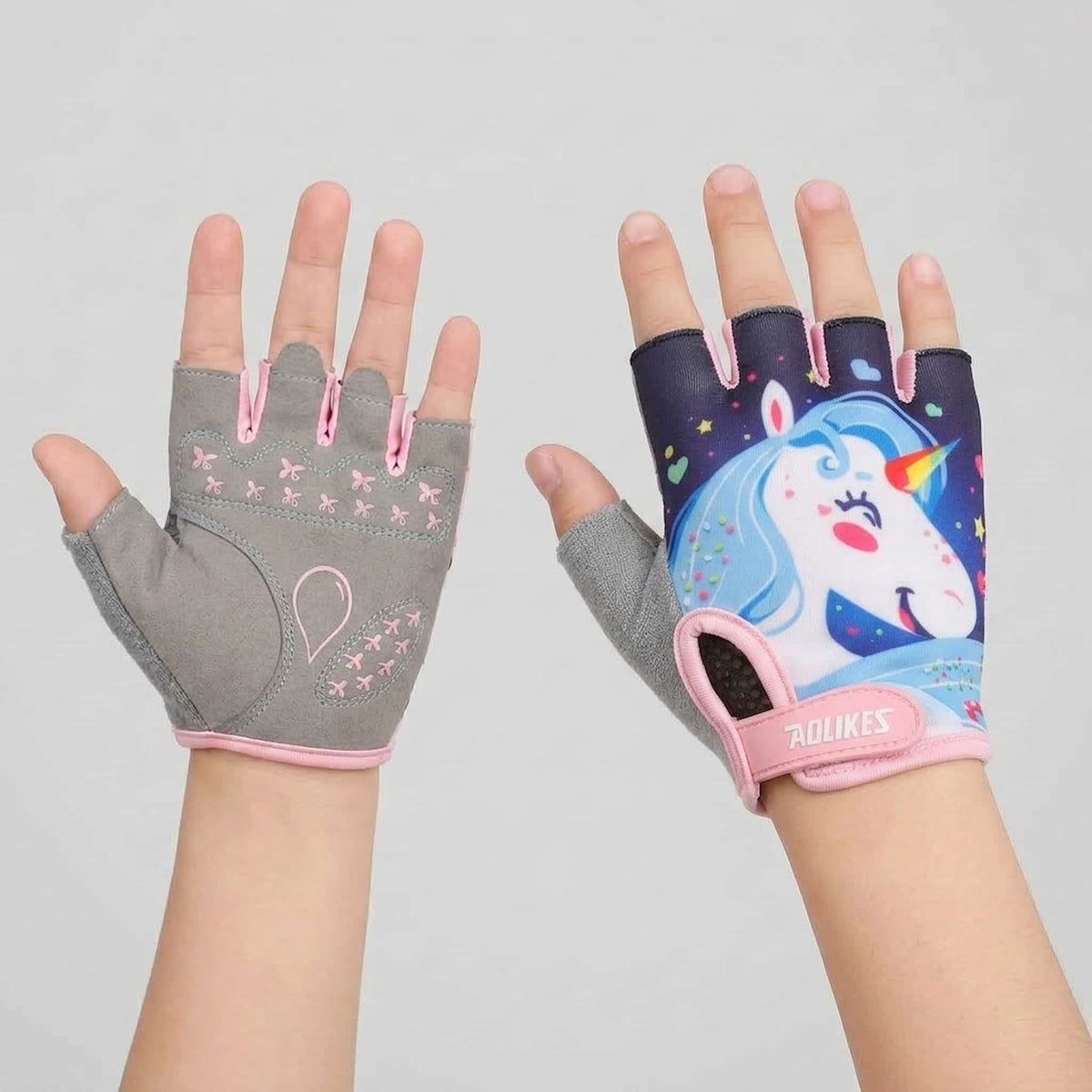 A pair of fingerless gloves for children worn on hands against a light gray background. 
