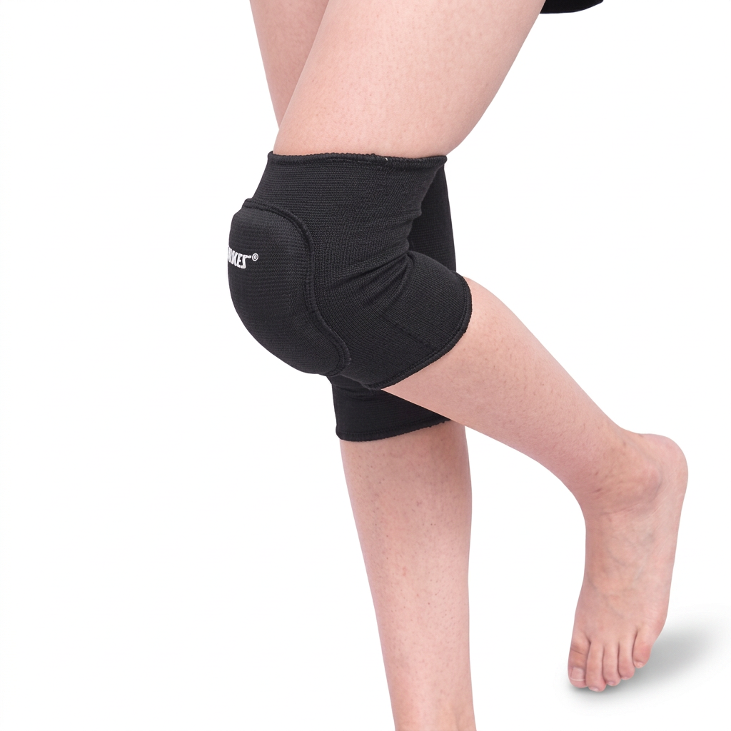 Side view of black padded children’s knee sleeves with one knee bent, showing the rounded front cushion.