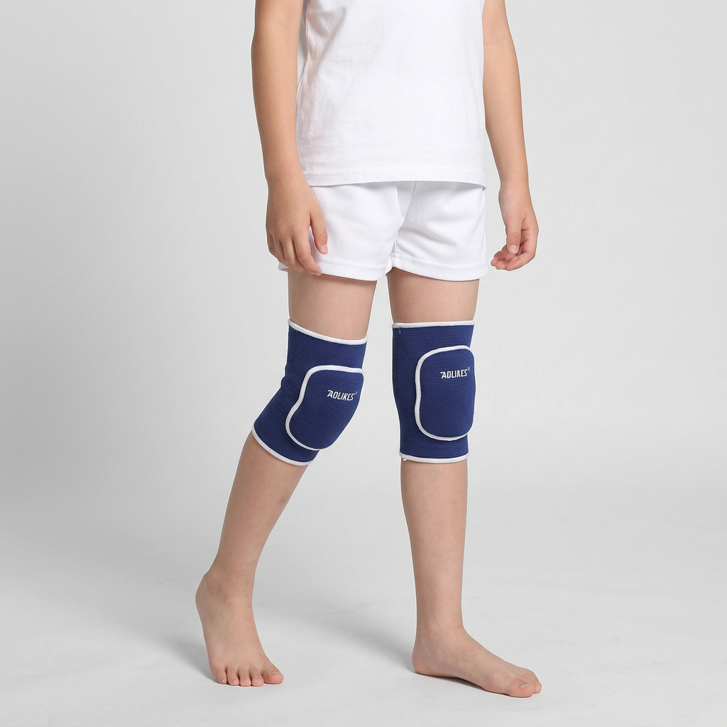 Child standing with one foot forward wearing blue kids knee pads with white trim and rounded front cushioning.