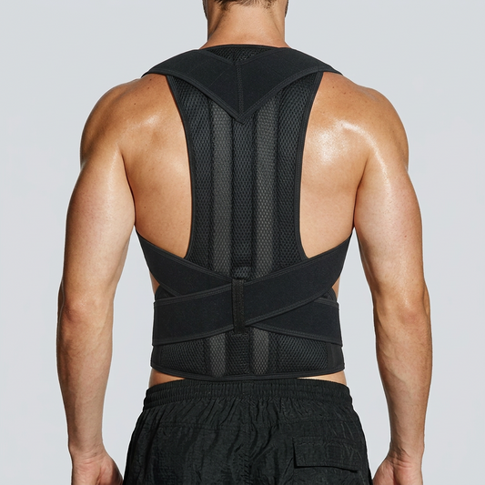 Rear three-quarter view of a male model wearing a black shoulder and lumbar posture brace with crossed waist straps and a long mesh back panel.