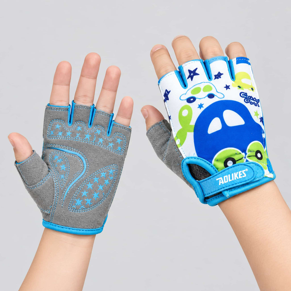 A pair of kids scooter riding gloves shown on hands against a light gray background. 