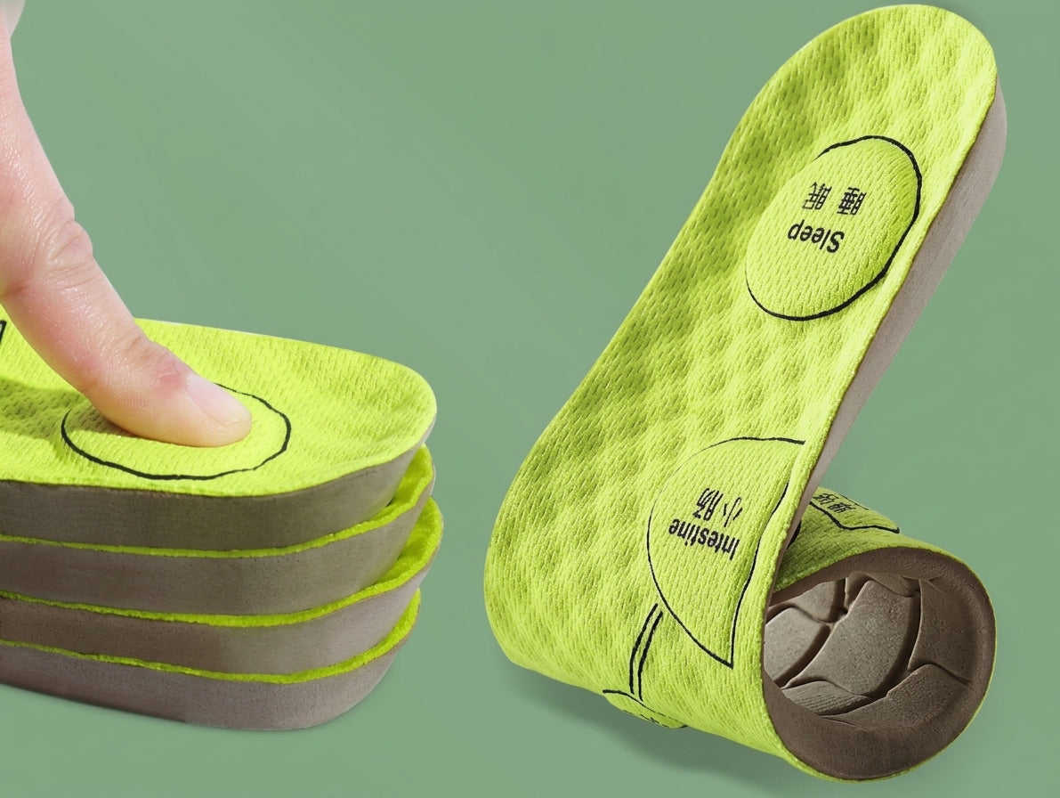 Bright lime green massage insoles for shoes with gray cushioning, shown with a finger pressing down on a stack of them and one sole curled up to display the interior support structure. The background is a solid sage green.