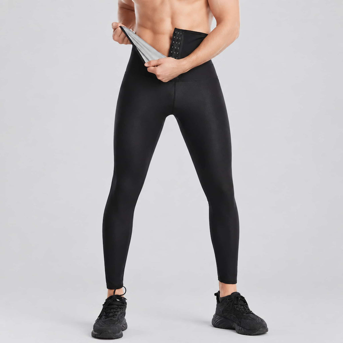 A model wearing sauna workout leggings for men, against a light gray studio background.