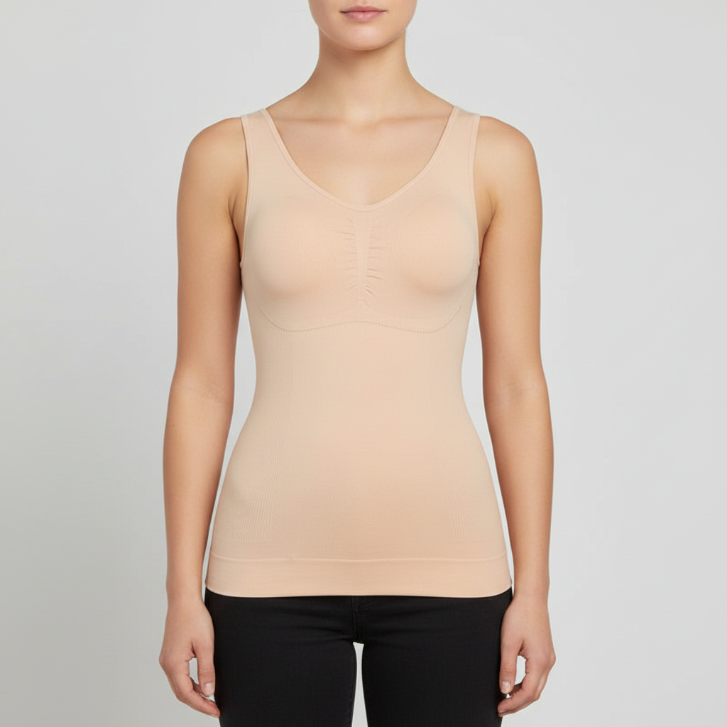 A woman wearing a seamless shapewear tank top with bra invisible under clothes, shown from the lips down against a light gray studio background.