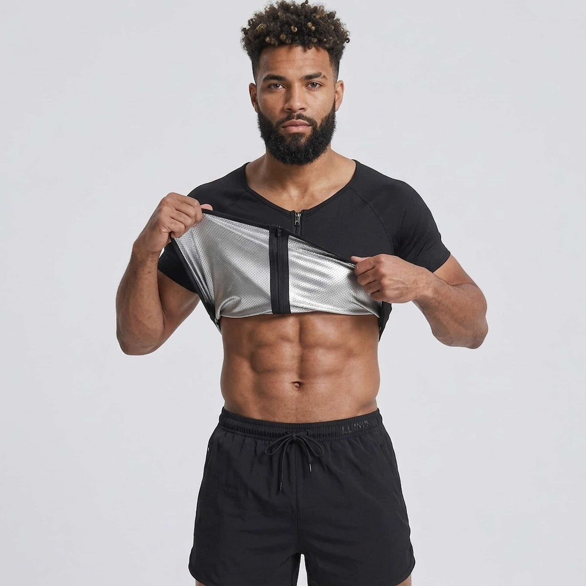 A man modeling a sweat shaper vest, against a light gray studio background.