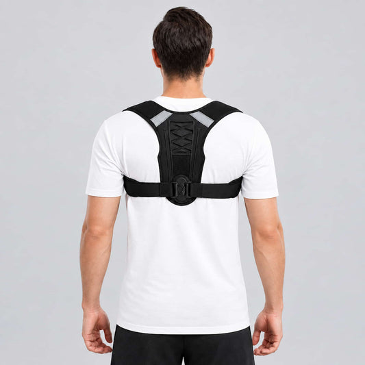A man viewed from behind wearing an upper back support brace with reflective gray shoulder straps over a white t-shirt, set against a solid gray studio background.