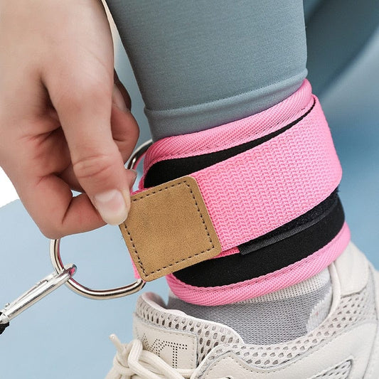 Pink Ankle Strap For Cable Machines highlighting its secure hook-and-loop closure fastened around an athlete's ankle.