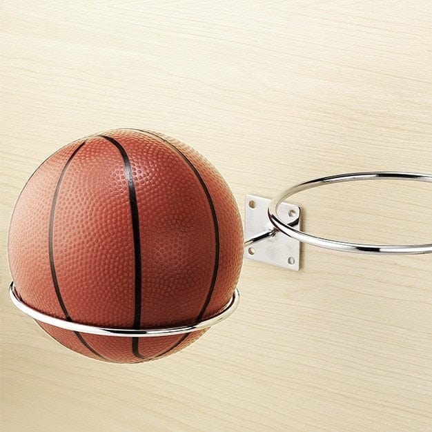 Silver Basketball Holder Wall Mount screwed into a wooden surface holding a classic leather basketball.