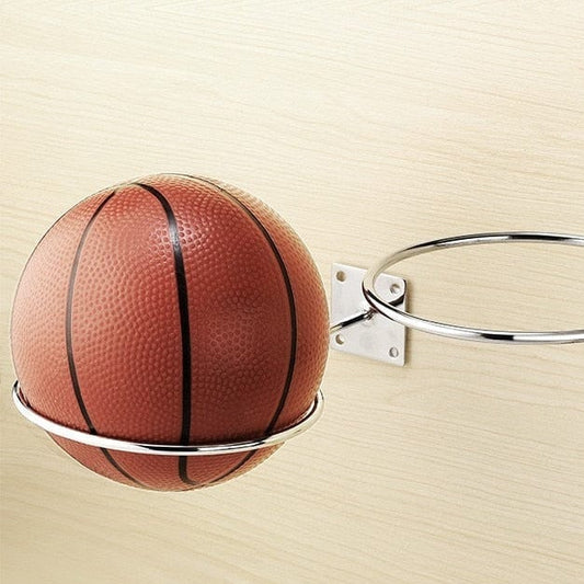 Silver Basketball Holder Wall Mount screwed into a wooden surface holding a classic leather basketball.