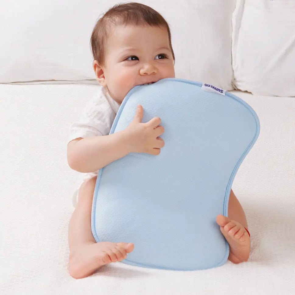 A baby holding the Ergonomic Baby Head Pillow