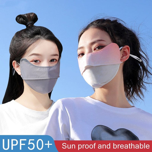 Two active women wearing light-colored UPF 50+ sun masks during an outdoor hike.