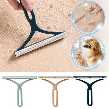 A person using a blue sticky lint roller to clean dog hair off a grey fabric couch.