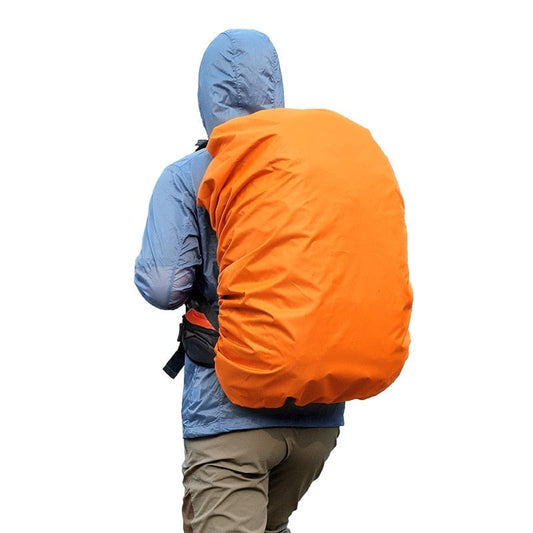 Commuter in the rain wearing an orange high-visibility reflective backpack cover.