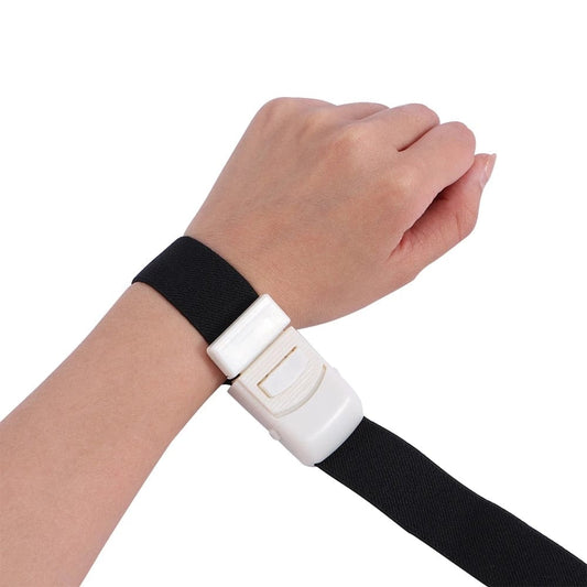 Close-up detail highlighting the quick-release locking mechanism on a black tactical trauma band.